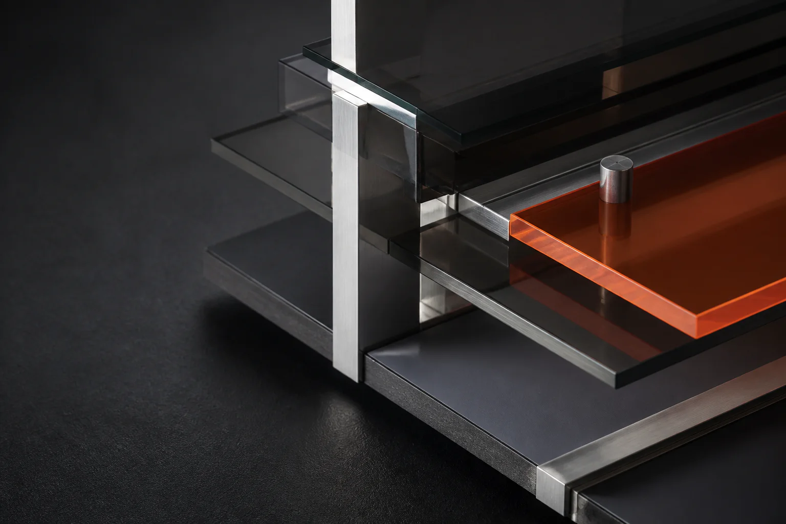 Smoked glass and brushed metal layers assembled into a precise commercial structure
